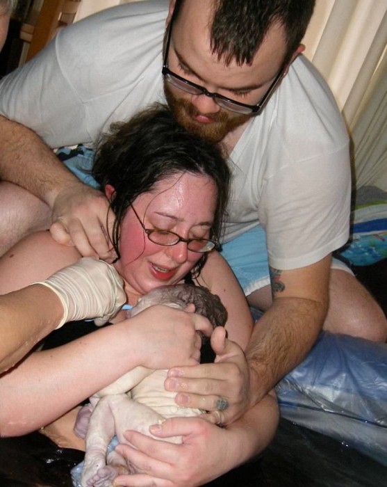 Toni brings baby up out of birthing tub